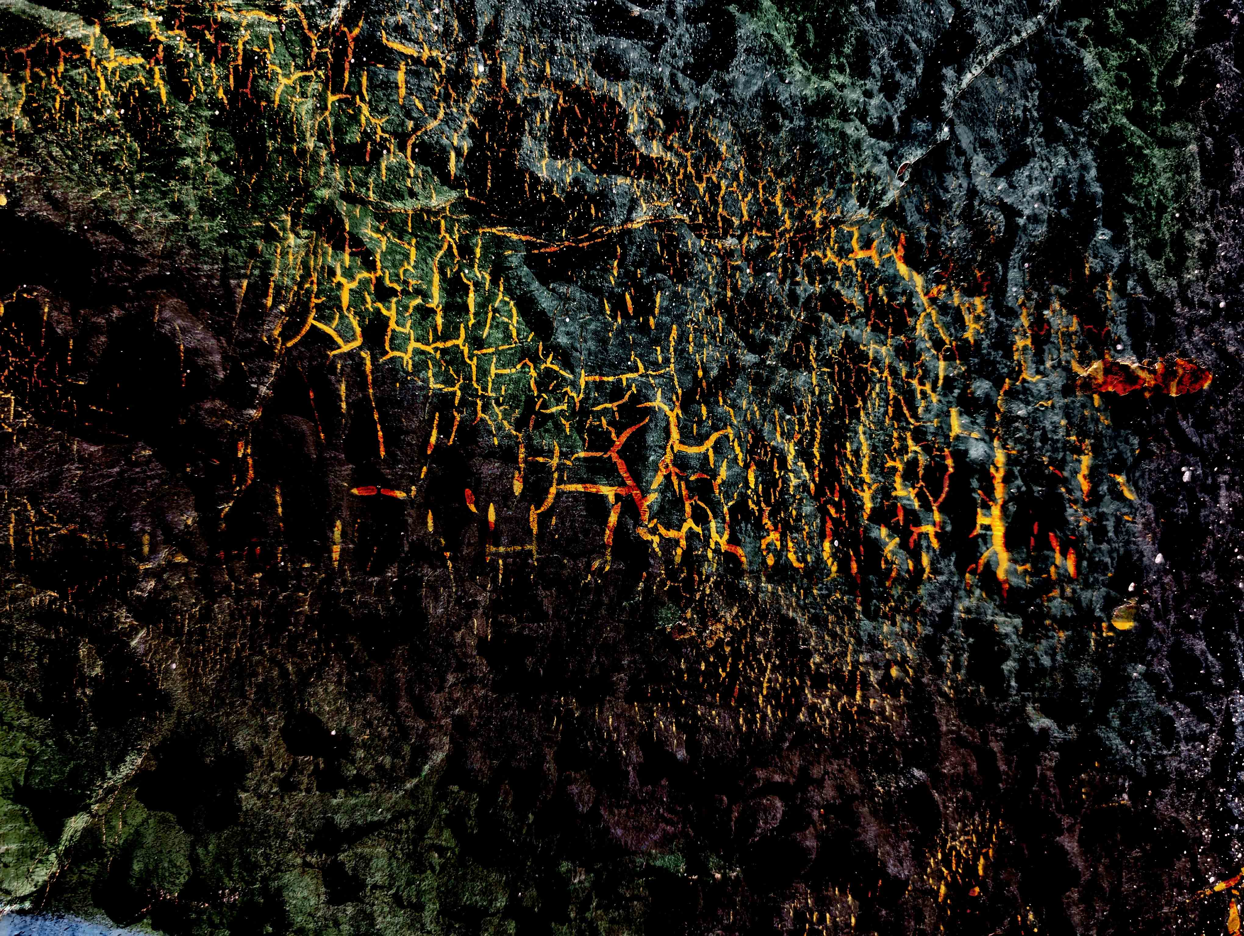 a stylized photograph of a painted wall overlaid on sand